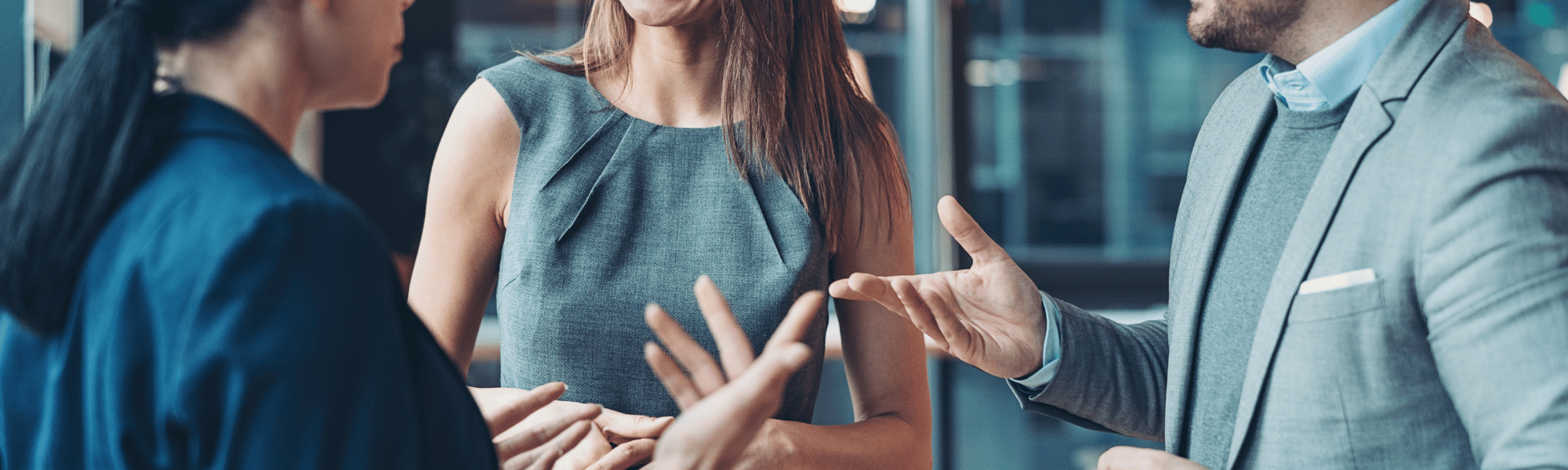 Professionals networking at an industry event, exchanging business cards and ideas